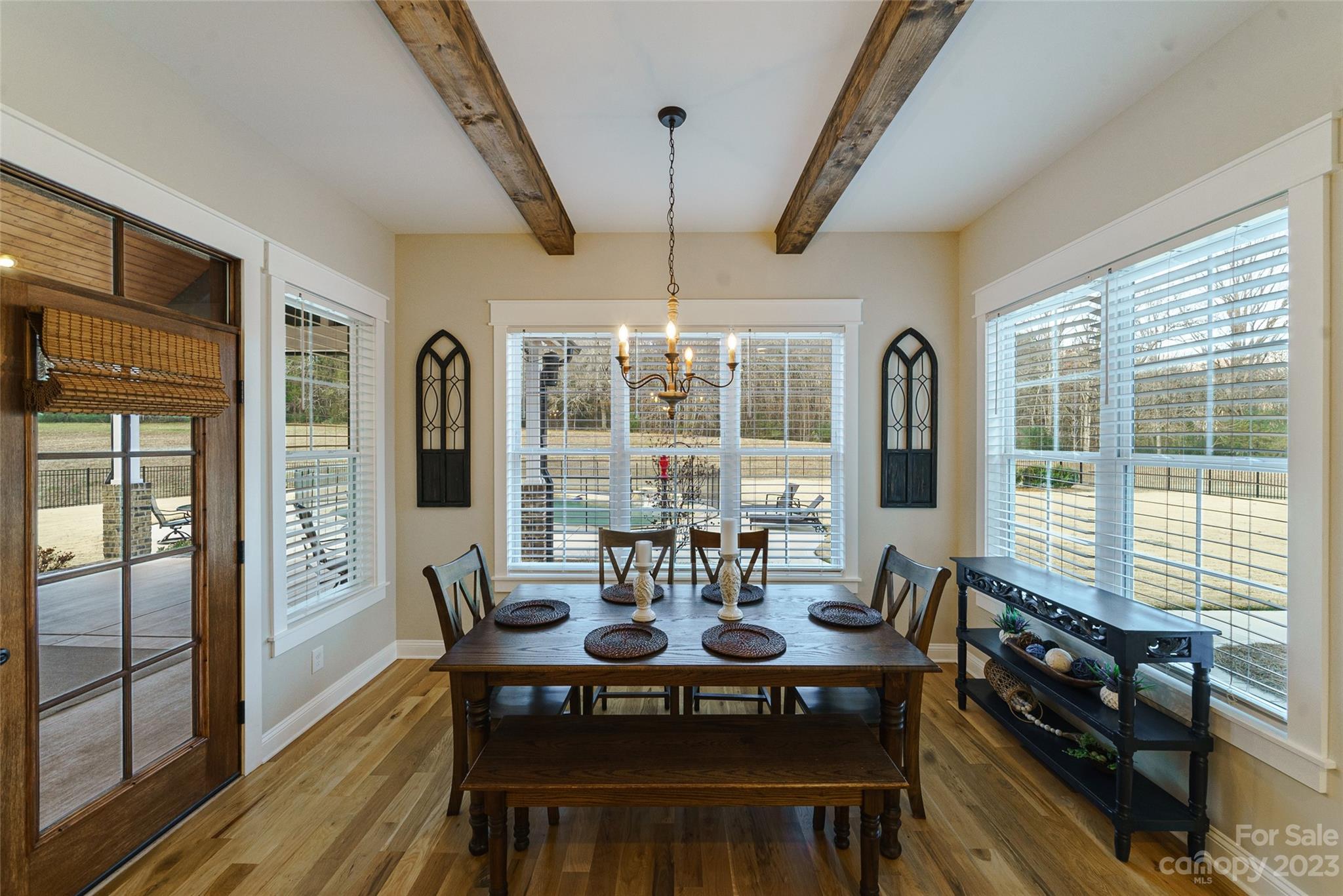 16063 McLester Road Oakboro, NC 28129 - Photo 19 of 48 a view of a dining room with furniture wooden floor and chandelier