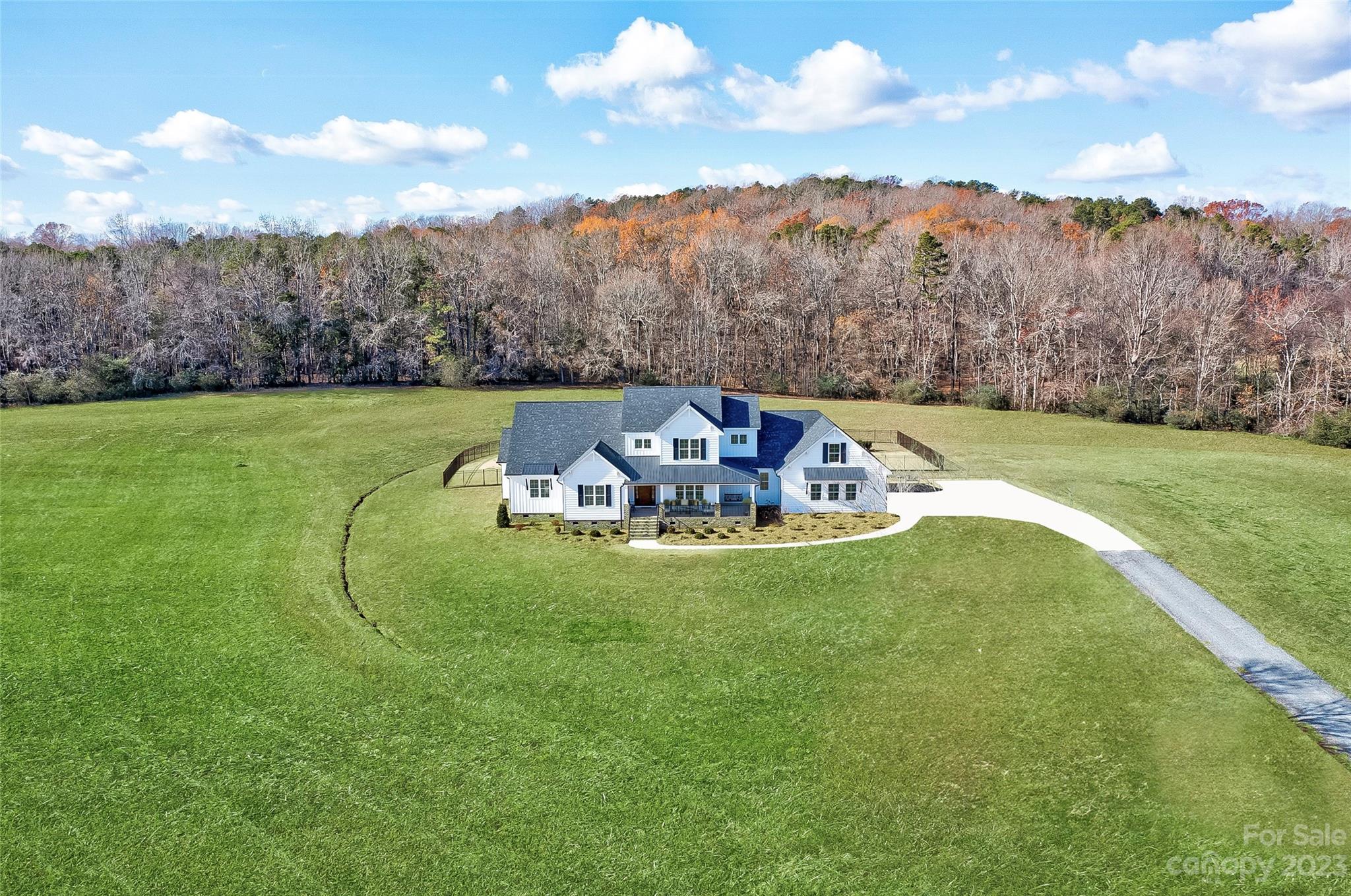16063 McLester Road Oakboro, NC 28129 - Photo 2 of 48 a view of a table and chairs in the grass
