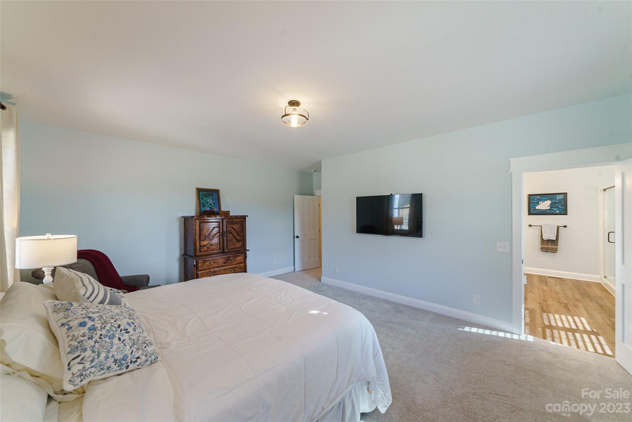16063 McLester Road Oakboro, NC 28129 - Photo 23 of 48 a bedroom with a bed and a flat screen tv