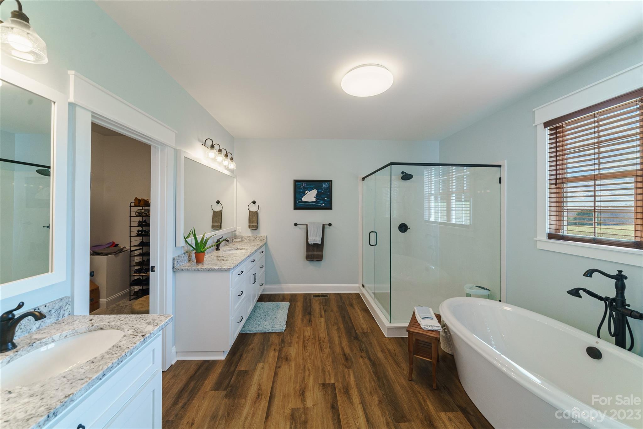 16063 McLester Road Oakboro, NC 28129 - Photo 25 of 48 a spacious bathroom with a granite countertop tub sink and mirror