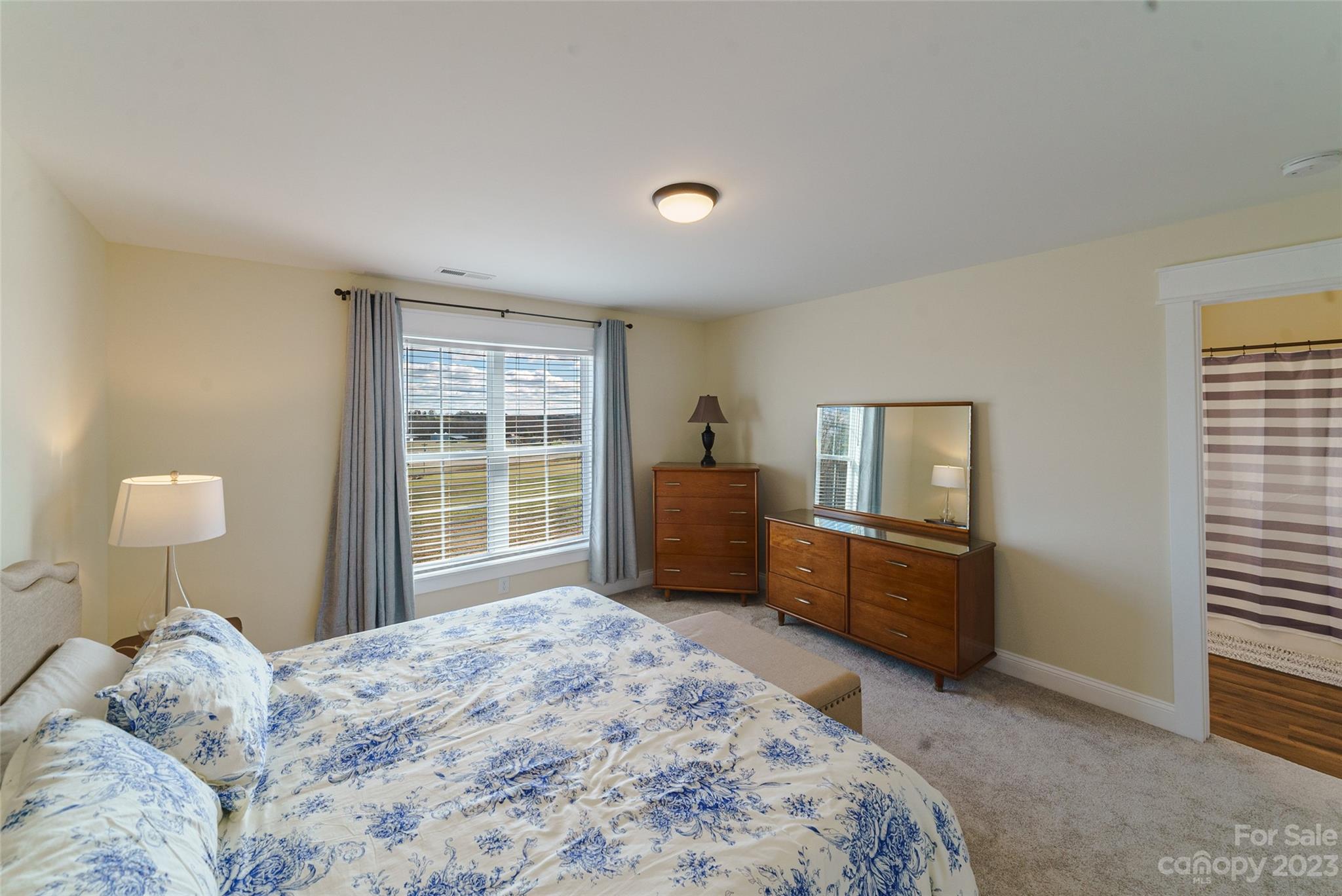 16063 McLester Road Oakboro, NC 28129 - Photo 26 of 48 a bedroom with a bed dresser and a window