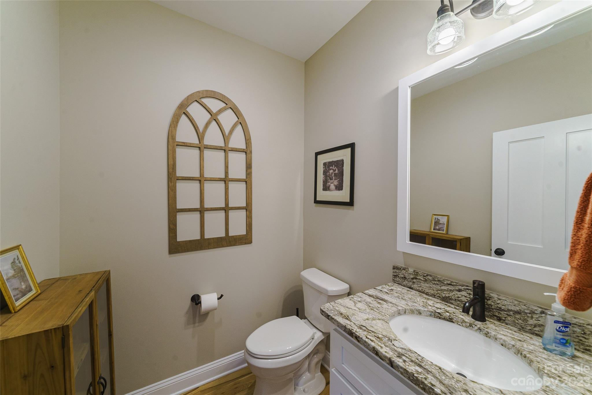 16063 McLester Road Oakboro, NC 28129 - Photo 30 of 48 a bathroom with a granite countertop toilet a sink and a mirror