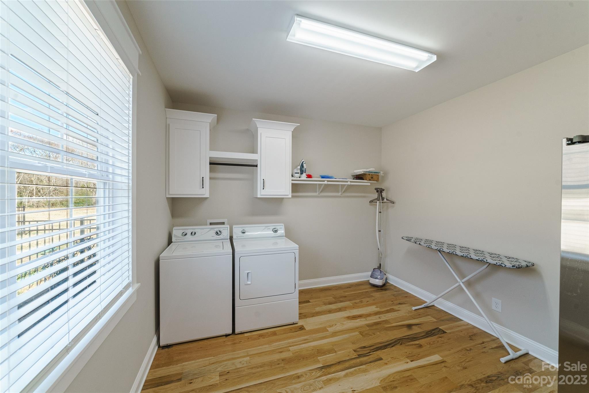16063 McLester Road Oakboro, NC 28129 - Photo 31 of 48 a storage room with wooden floor washer and dryer