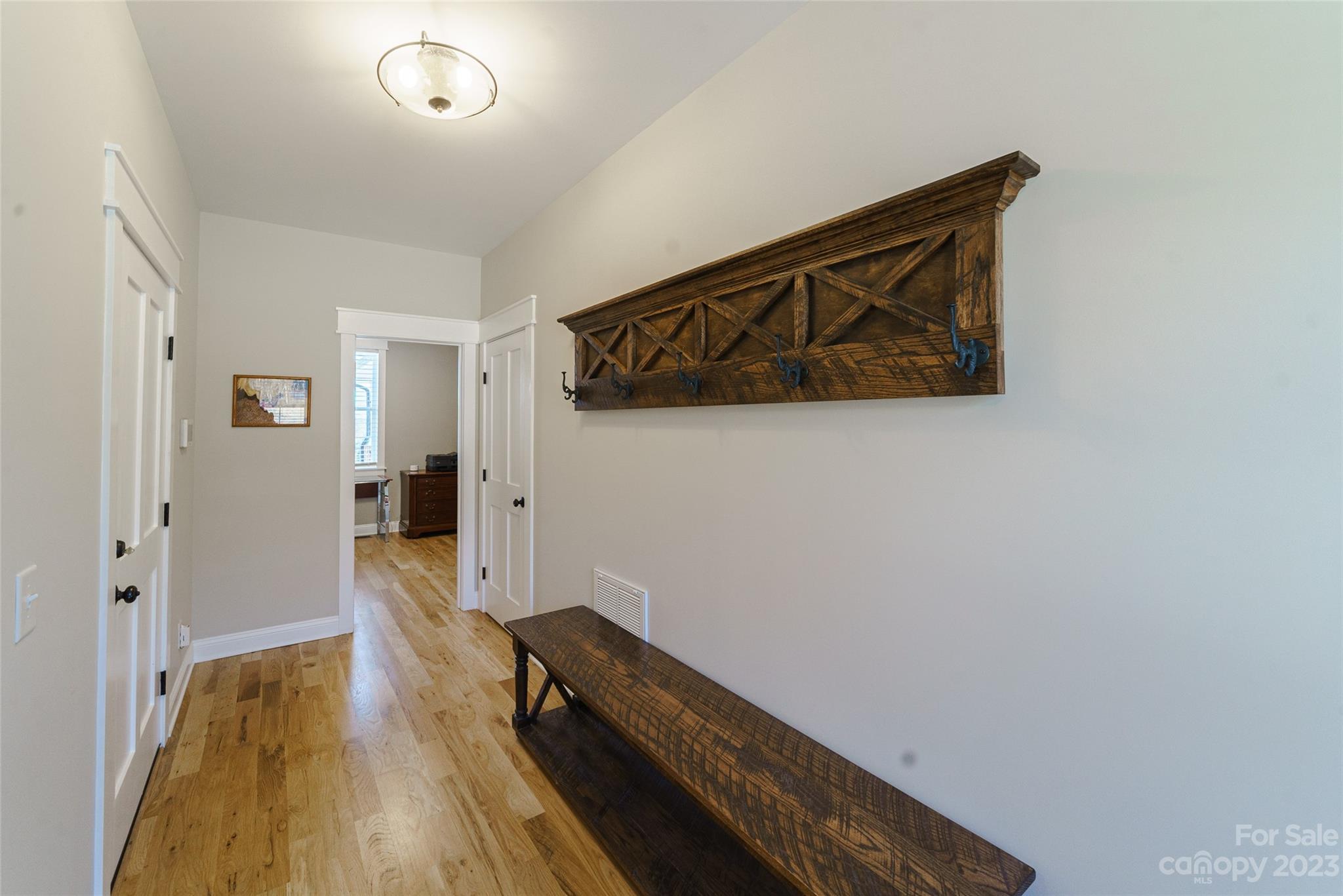16063 McLester Road Oakboro, NC 28129 - Photo 32 of 48 a view of a hallway with wooden floor and a bathroom