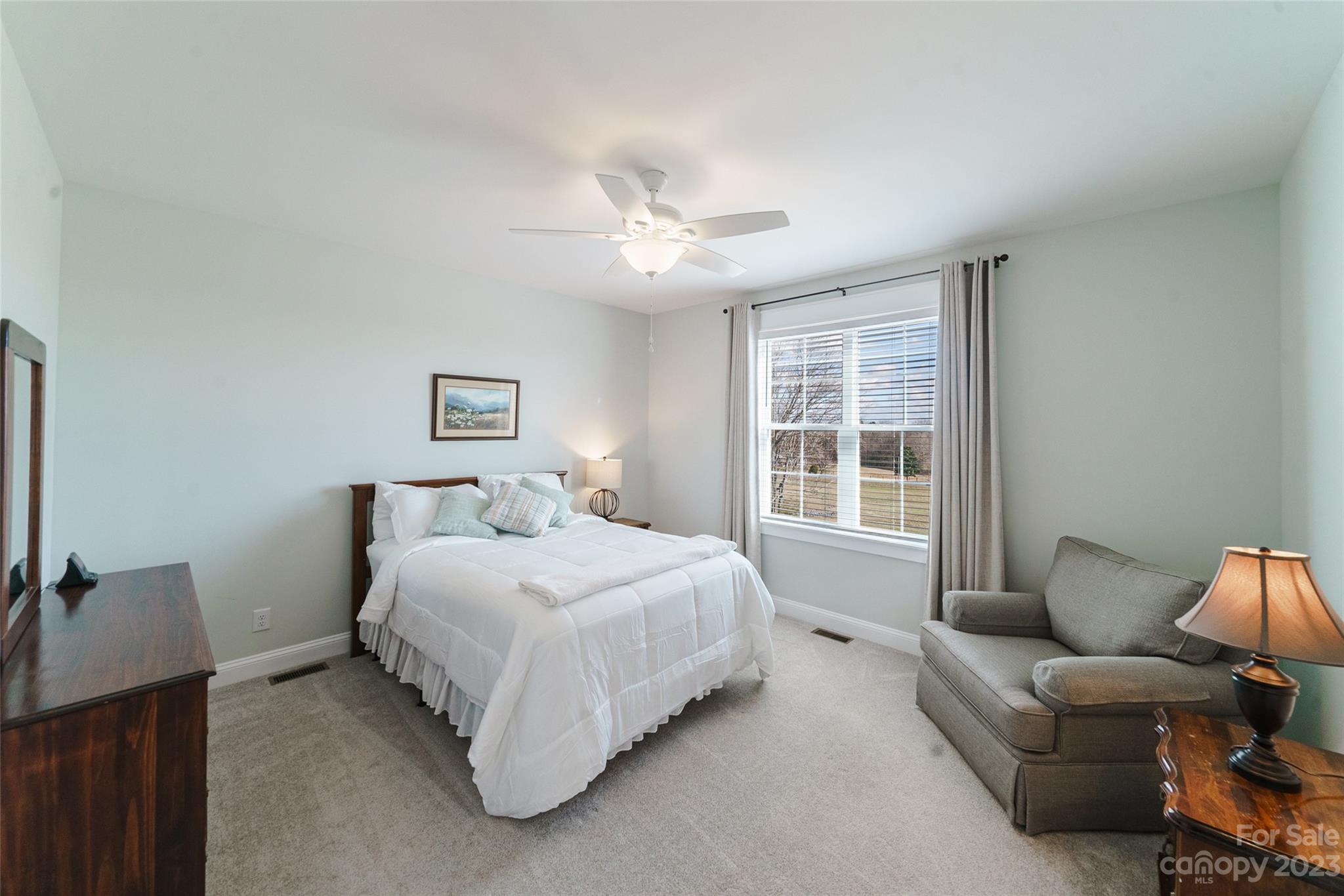16063 McLester Road Oakboro, NC 28129 - Photo 36 of 48 a spacious bedroom with a bed couch and a window