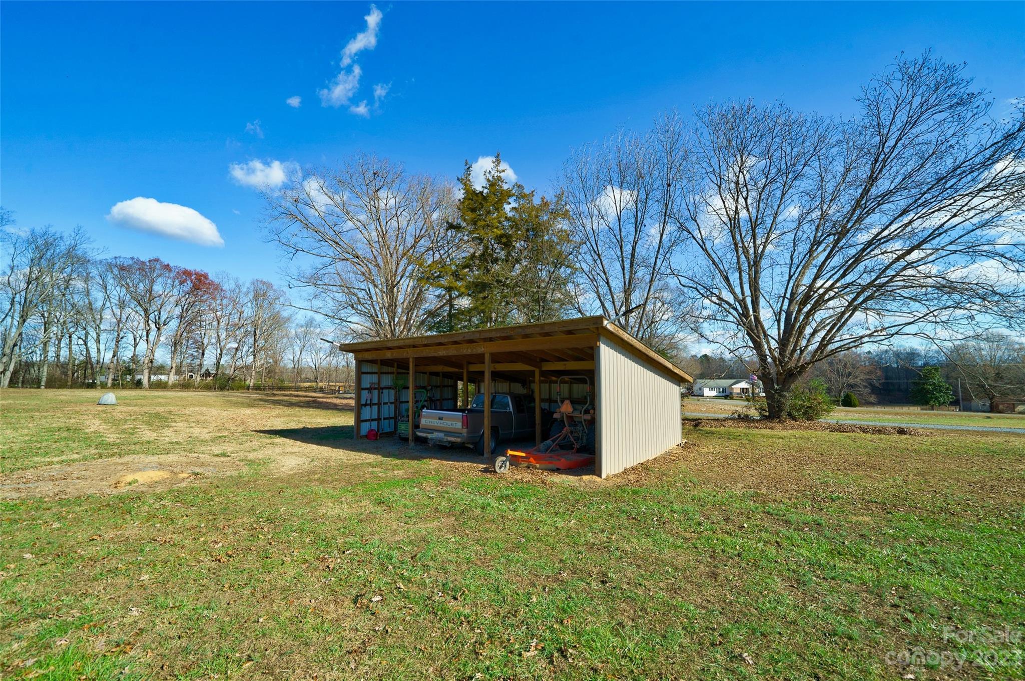 16063 McLester Road Oakboro, NC 28129 - Photo 46 of 48 a view of a house with backyard and trees
