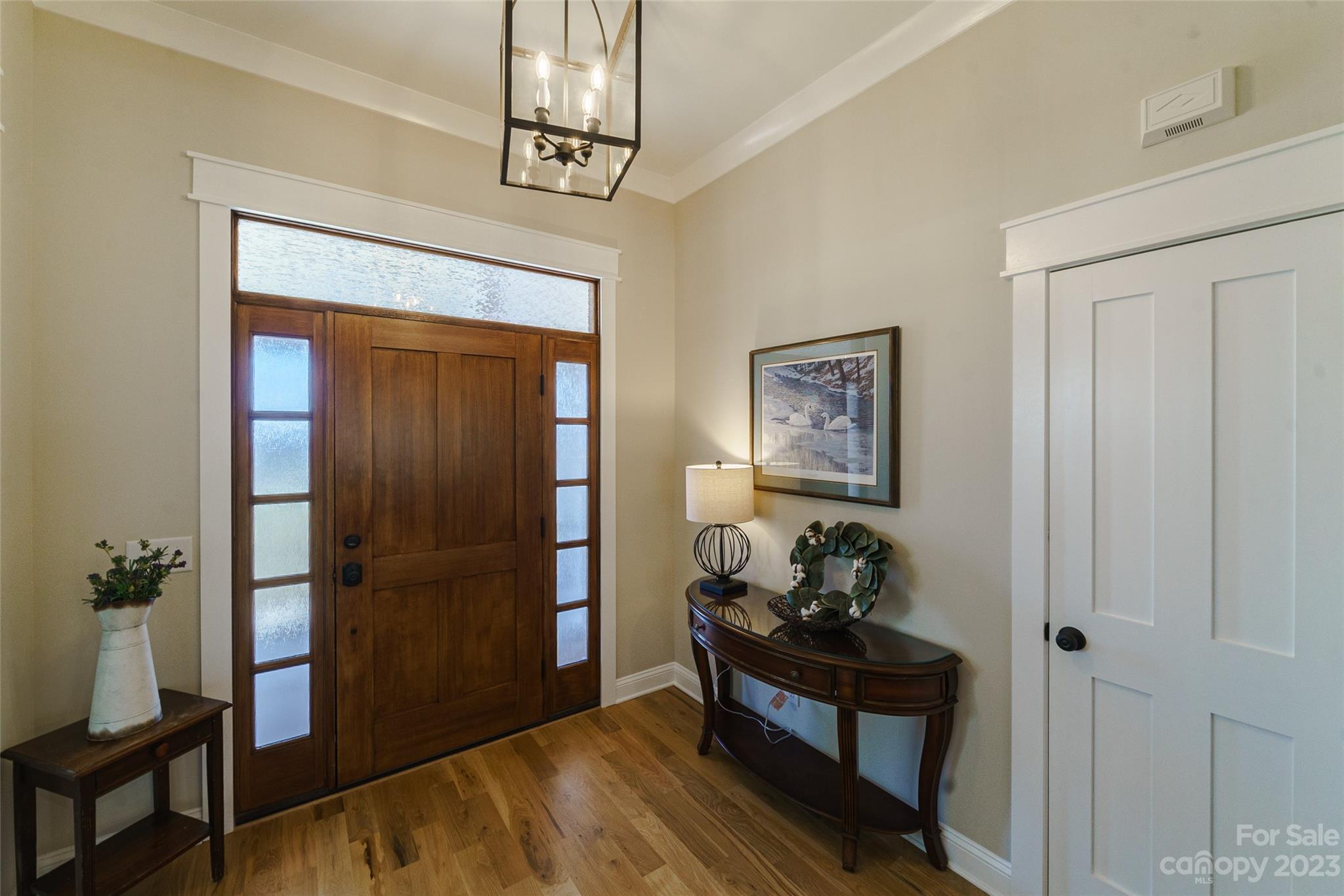 16063 McLester Road Oakboro, NC 28129 - Photo 7 of 48 a bedroom with a bed and a chandelier