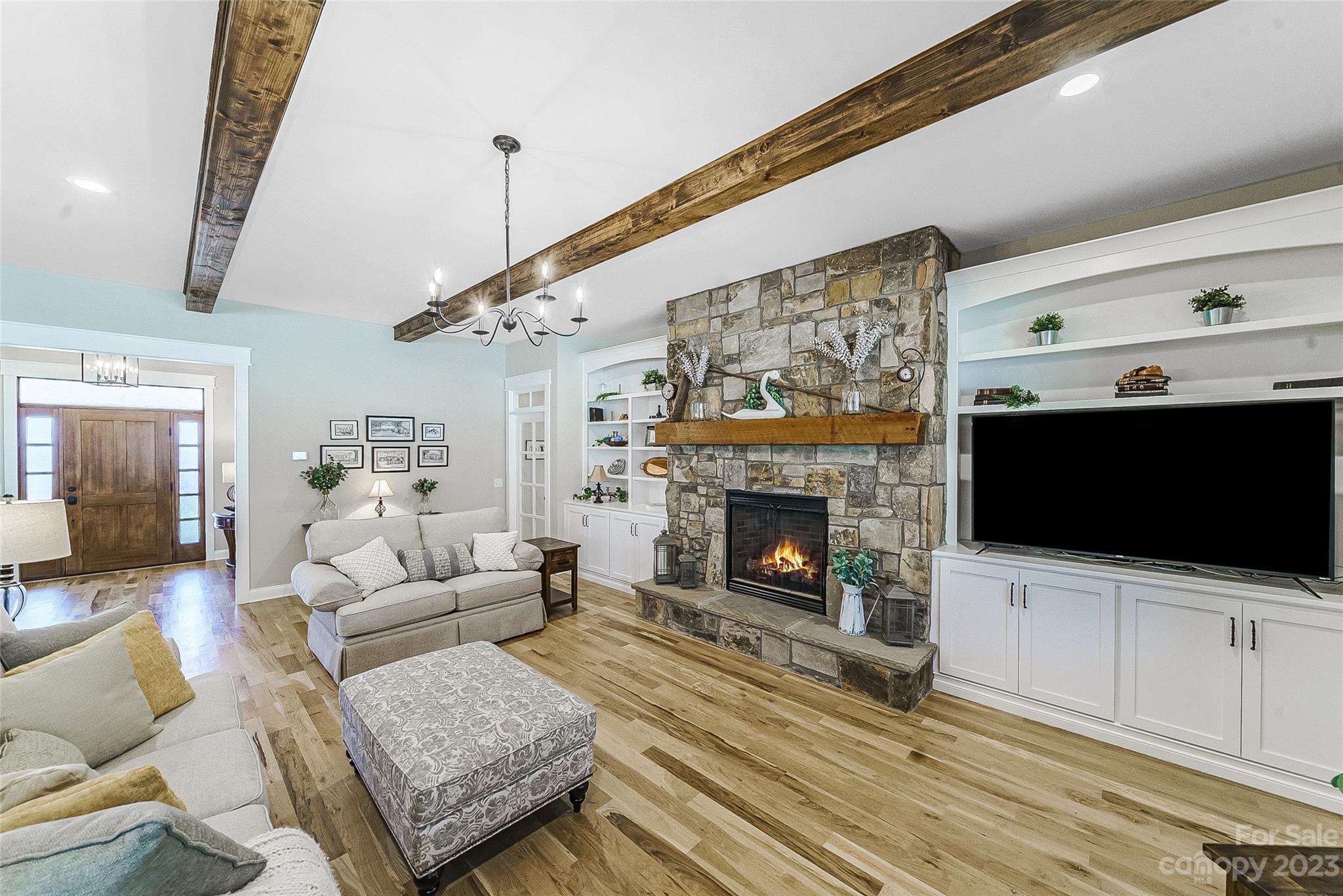16063 McLester Road Oakboro, NC 28129 - Photo 9 of 48 a living room with furniture a flat screen tv and a fireplace
