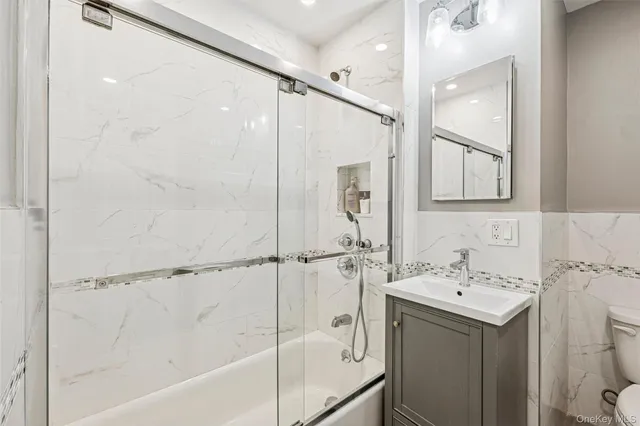 a bathroom with a sink mirror and a bathtub