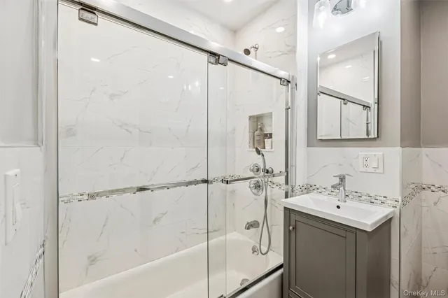 a bathroom with a bathtub a shower a sink and a mirror