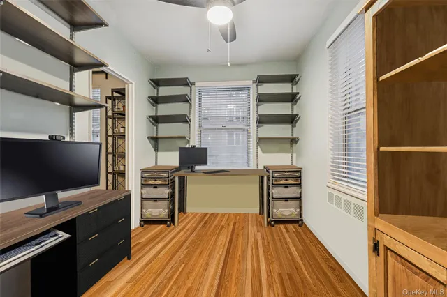 a kitchen view with wooden floor stainless steel appliances and cabinets