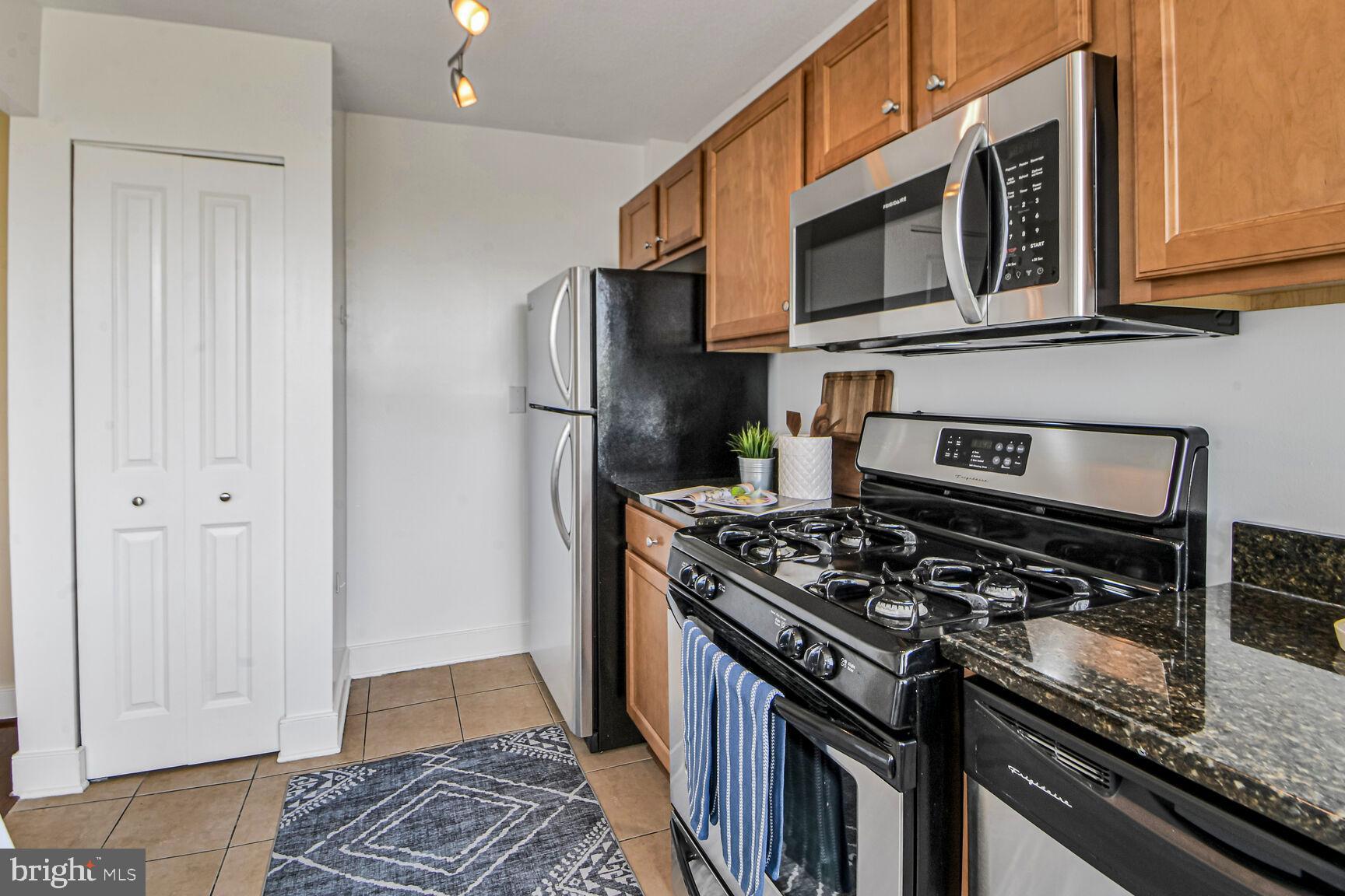 1220 Blair Mill Road, Unit 605 Silver Spring, MD 20910 - Photo 19 of 46 a kitchen with stainless steel appliances granite countertop a stove and a refrigerator