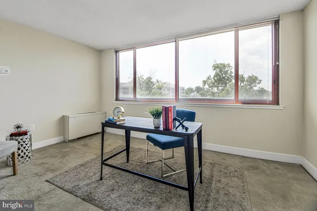 a view of a livingroom with furniture and a window