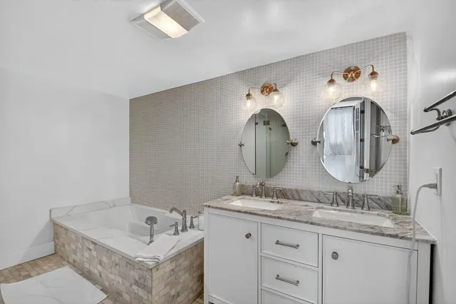 a bathroom with a double vanity sink and a mirror