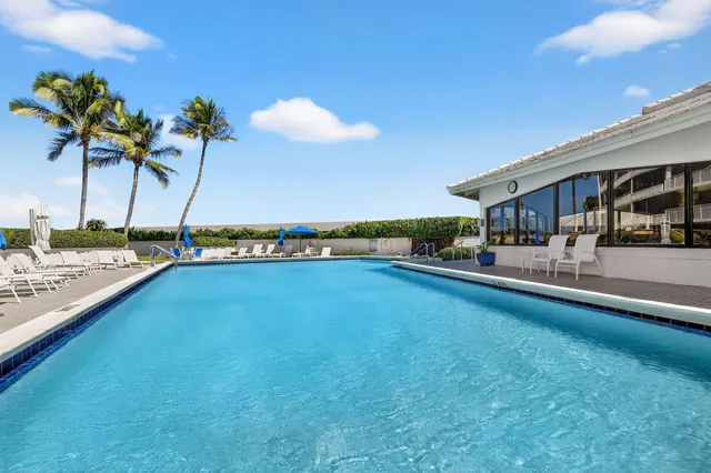 a view of a swimming pool and lounge chair