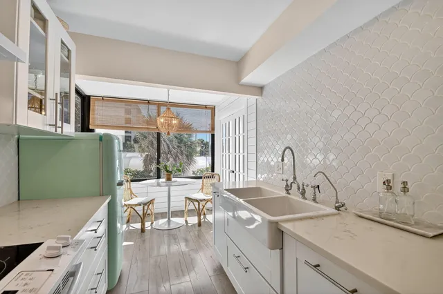 a view of a kitchen with a sink and a large window