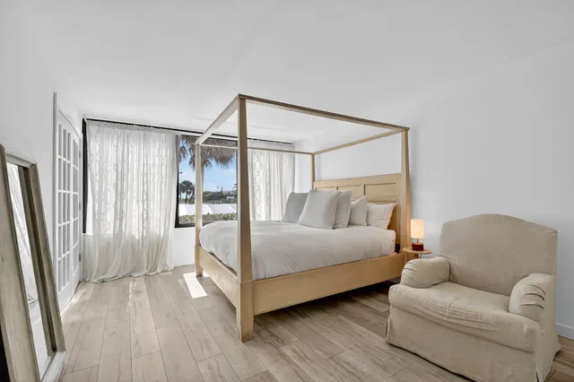 a bedroom with a bed couch and a window