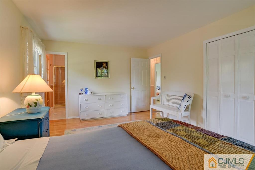 25 Indiana Road Somerset, NJ 08873 - Photo 22 of 25 a bedroom with a bed and a lamp on table