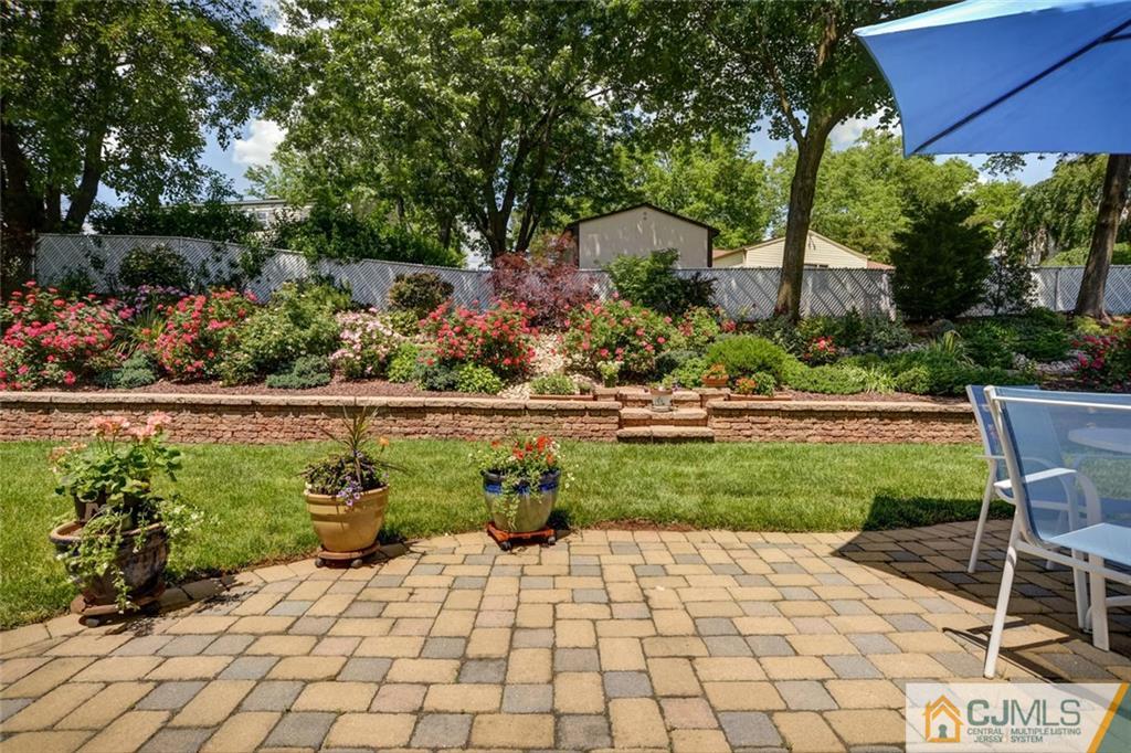 25 Indiana Road Somerset, NJ 08873 - Photo 25 of 25 a view of a chair and table in back yard of the house