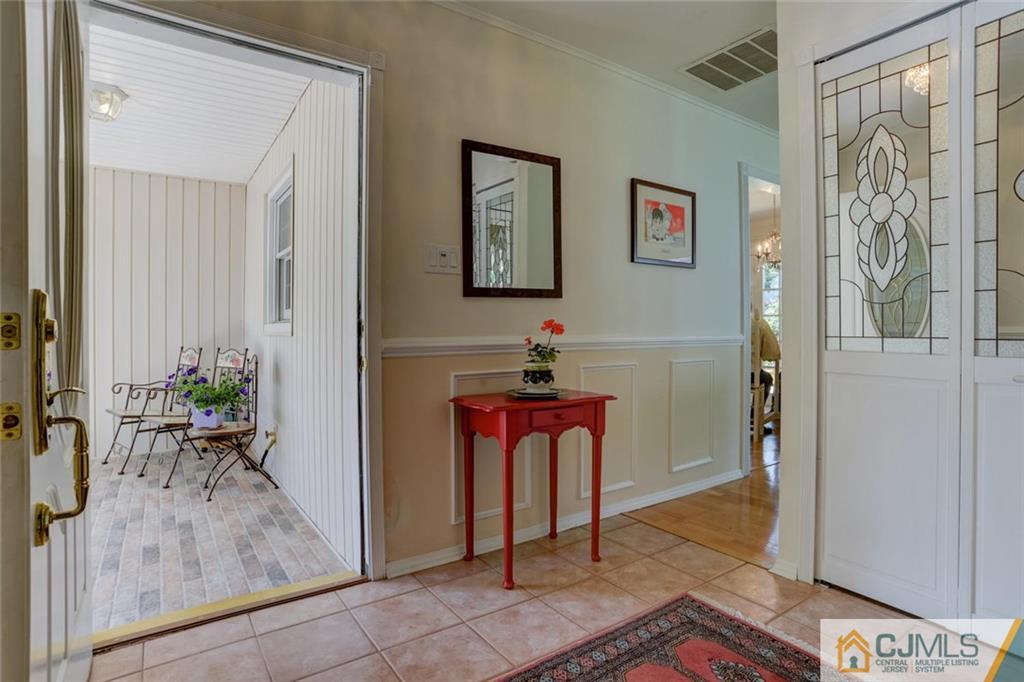 25 Indiana Road Somerset, NJ 08873 - Photo 7 of 25 a hallway with beautiful frames and flower vase