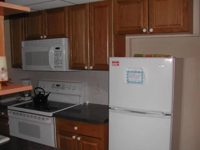 a kitchen with a refrigerator and cabinets