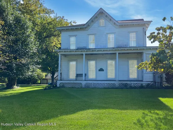 a front view of a house with a garden