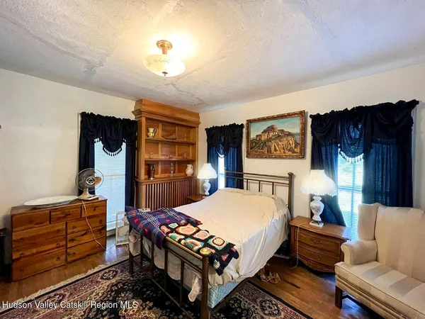 a bed room with a bed window and dresser