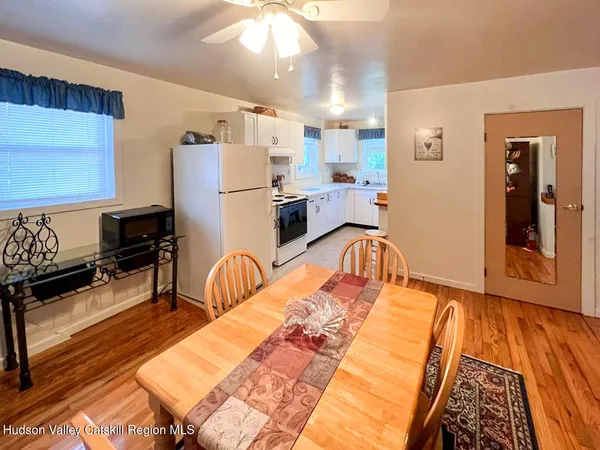 a living room with furniture fireplace and a window