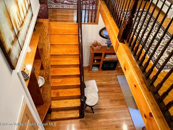 a view of staircase with railing and a chandelier
