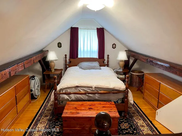 a backyard of a house with plants and large tree