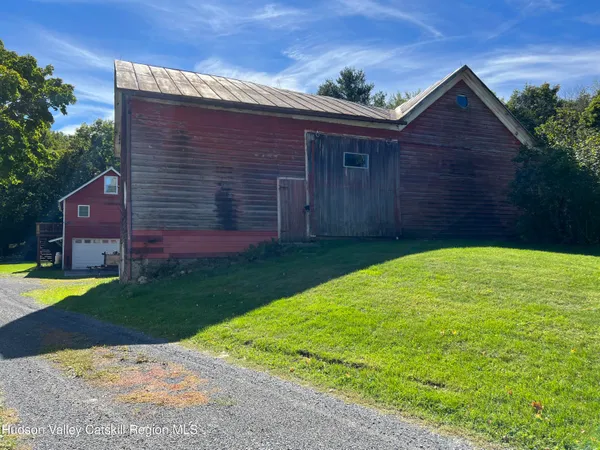 a front view of house with a garden