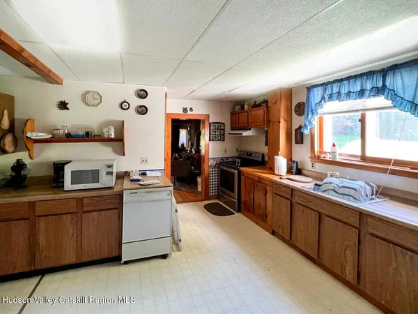 a kitchen with cabinets a sink and appliances