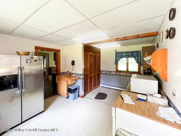 a kitchen with stainless steel appliances kitchen island granite countertop a refrigerator and a sink