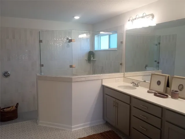 a bathroom with a double vanity sink and a mirror