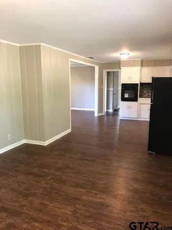 a kitchen with granite countertop white cabinets and black appliances