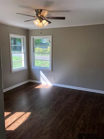a view of room with window and wooden floor