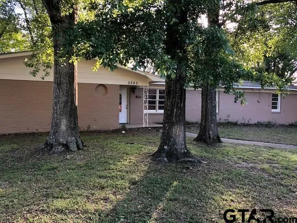 a house with a tree in front of it