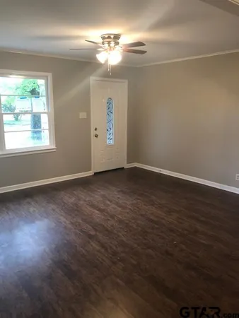 a kitchen with granite countertop white cabinets and black appliances