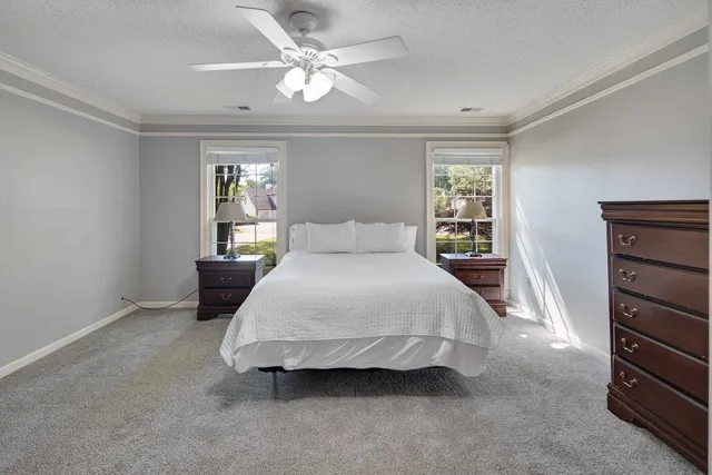 a spacious bedroom with a bed and a chandelier