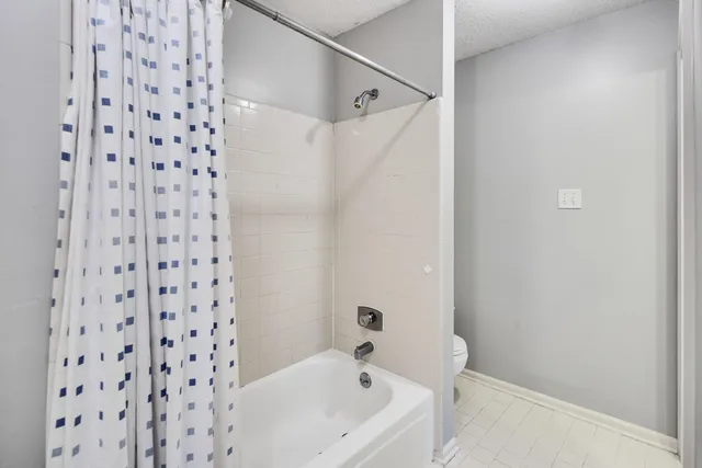 a bathroom with a bathtub and shower