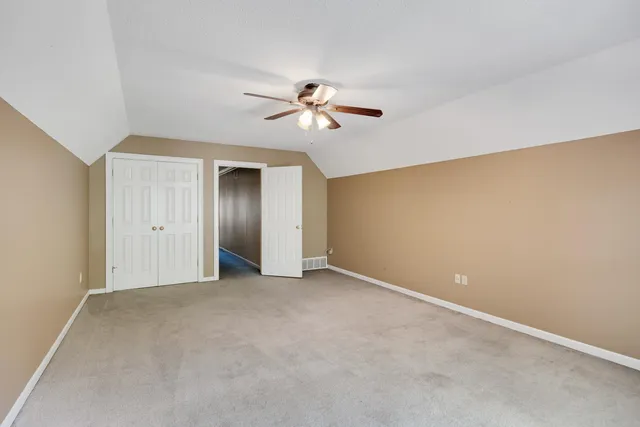 a view of a room with a ceiling fan and a window