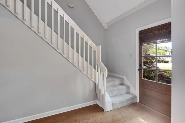 a view of staircase with white walls and windows