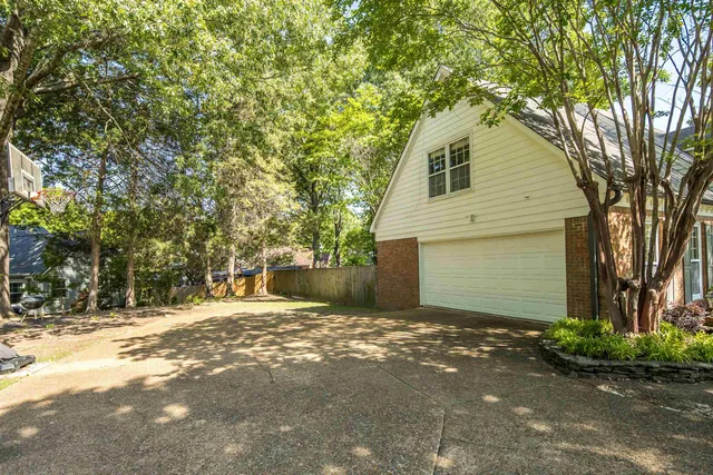 a swimming pool with trees in the background