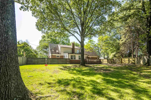 a view of house with yard