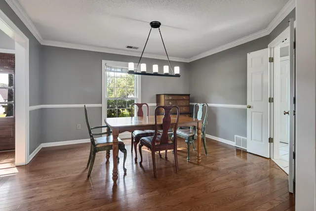 a view of a dining room with furniture window and wooden floor