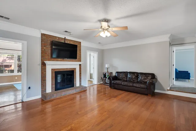 a living room with furniture fireplace and flat screen tv