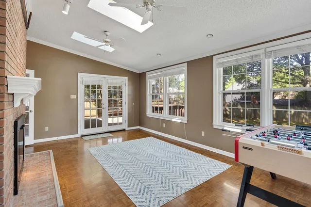 a living room with fireplace furniture and a large window