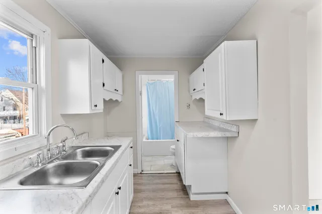 a kitchen with white cabinets and a sink