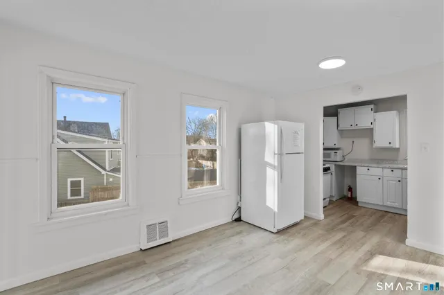 a view of a kitchen with a sink and a refrigerator