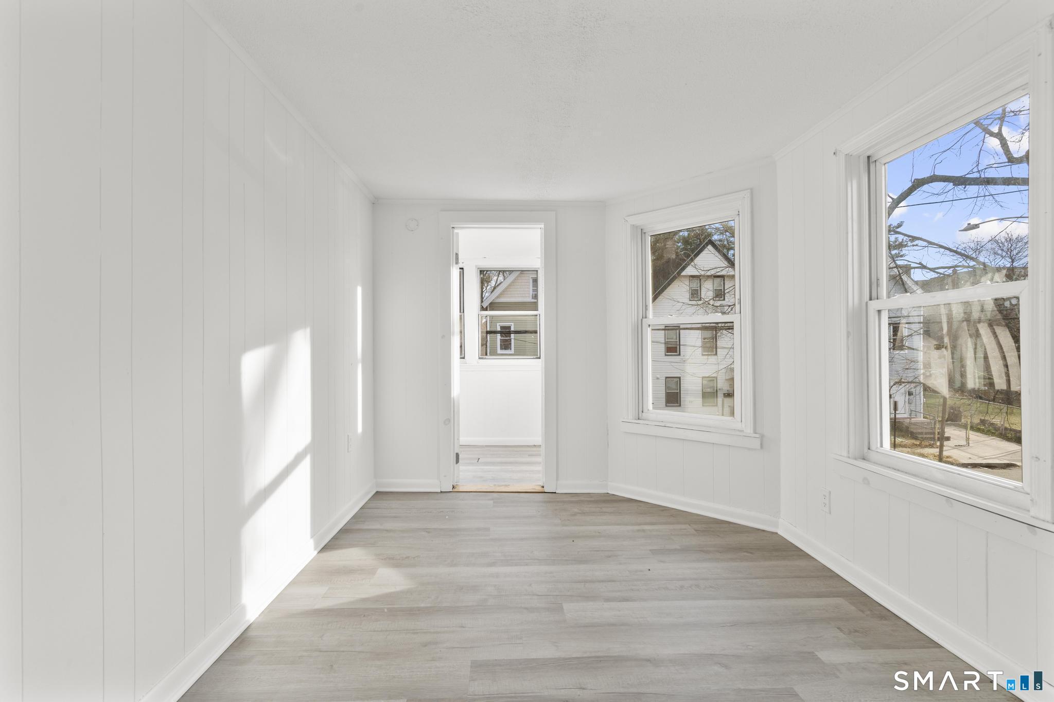 426 Poplar Street New Haven, CT 06513 - Photo 7 of 25 a view of an empty room with a window and wooden floor